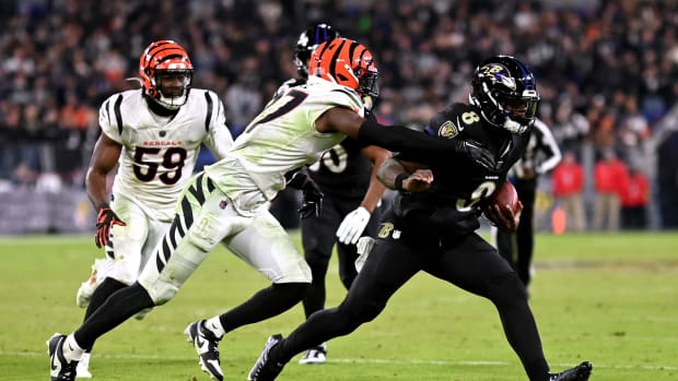 Nov 16, 2023; Baltimore, Maryland, USA; Cincinnati Bengals safety Jordan Battle (27) tackles Baltimore Ravens quarterback Lamar Jackson (8) during the fourth quarter at M&T Bank Stadium. Mandatory Credit: Tommy Gilligan-USA TODAY Sports  